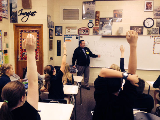 Students at St. Thomas the Apostle school in Elkhart raise their hands to answer a question